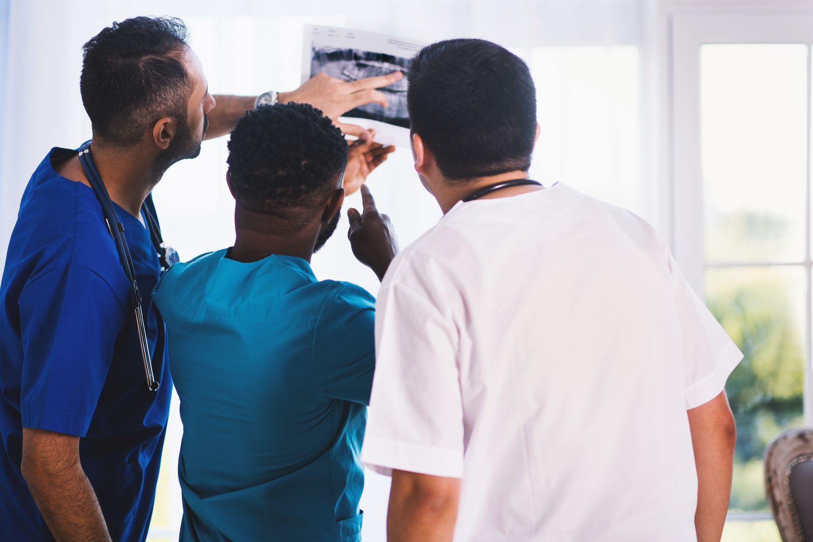 Clinical team reviewing an image in a bright medical office