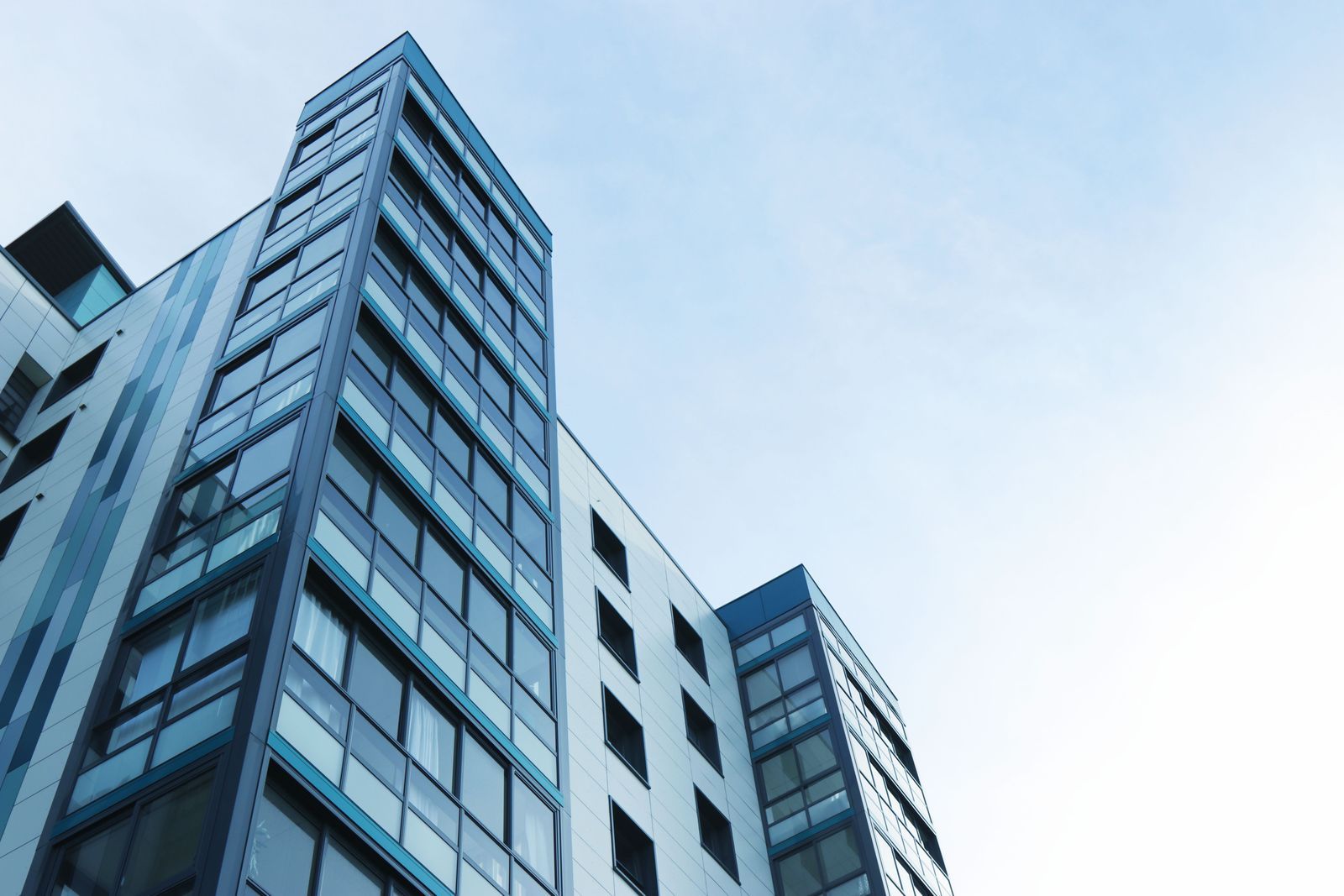 Glass residential tower photographed from street level