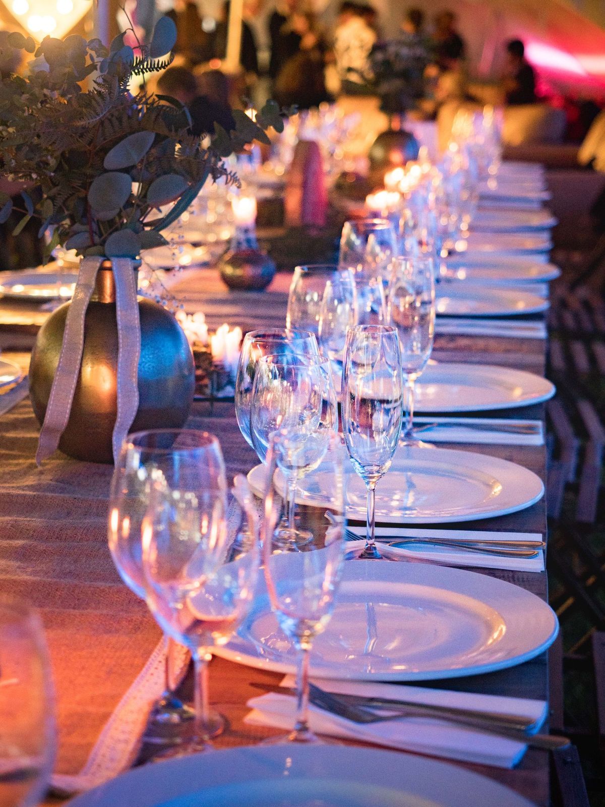 Long banquet table dressed with glassware for an event