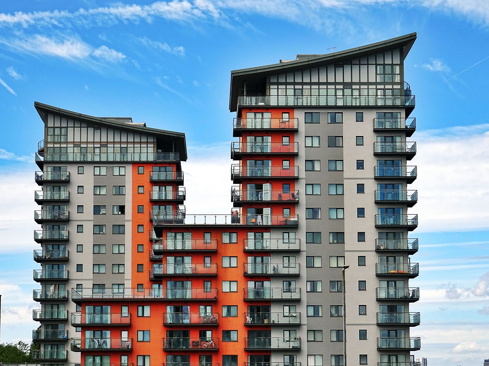 Modern apartment building with balconies under a blue sky