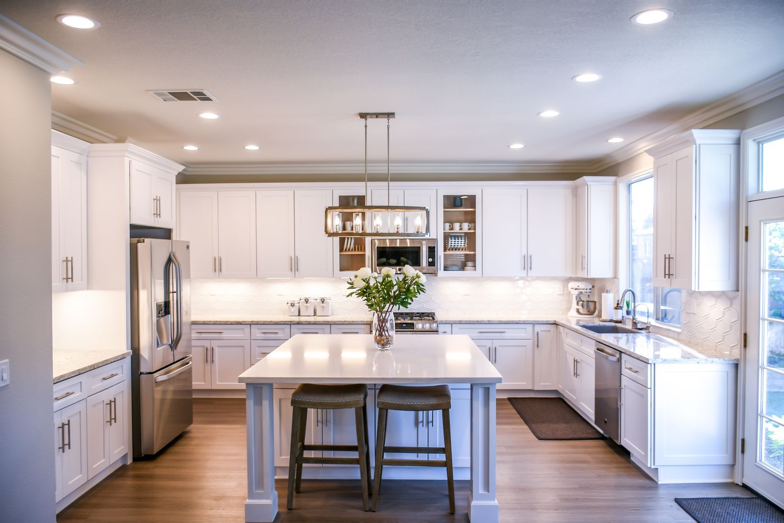 Bright white family kitchen kept spotless by a recurring house cleaning plan
