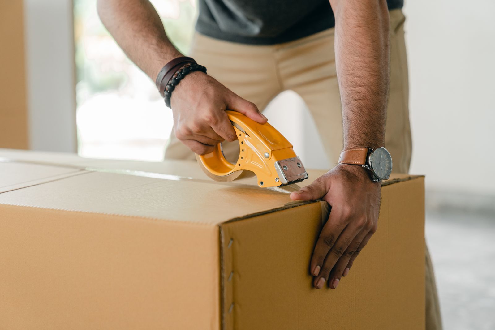 Moving box being sealed before a move out cleaning appointment